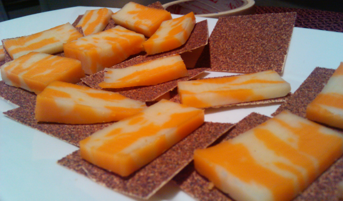 Photograph of hors d'oeuvres: slices of cheese on sandpaper